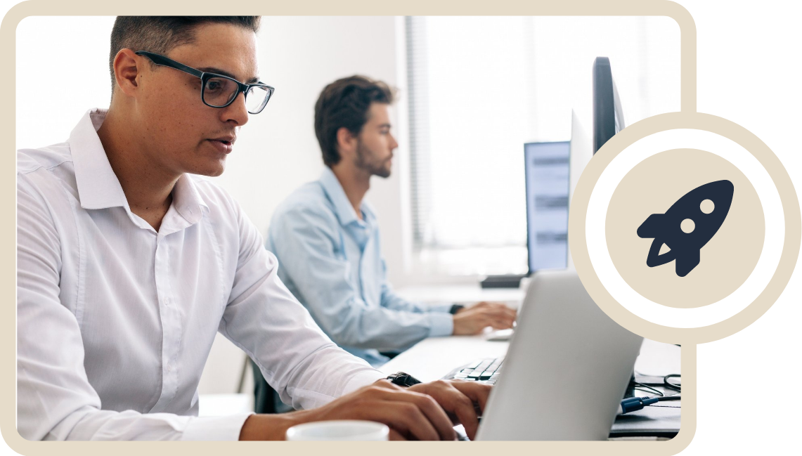 guy on computer with co worker in background